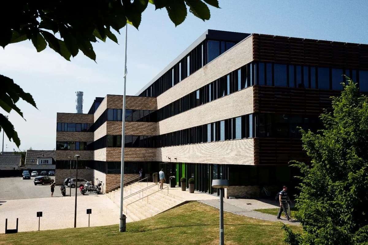 Modern police station building with brick and glass stripes on a sunny day.