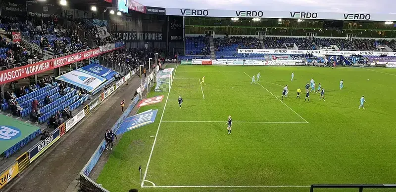 Football match at Randers Stadium with players and spectators