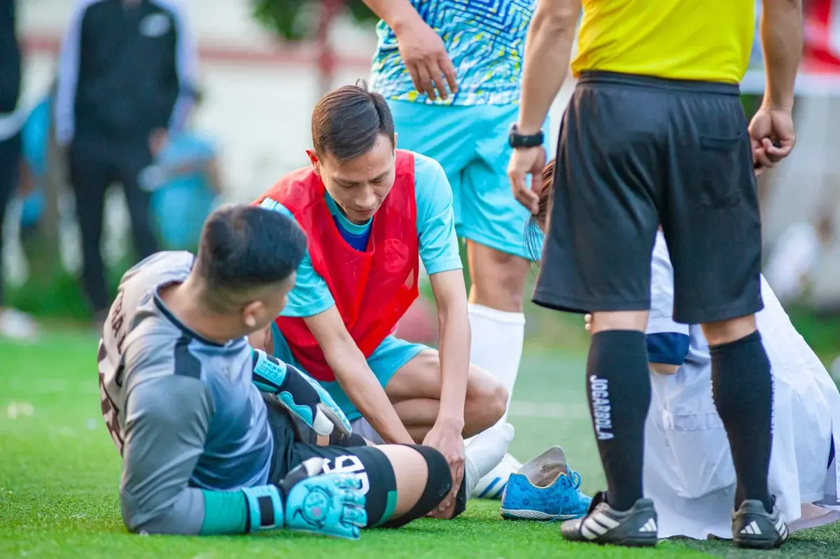 Injured football player receiving assistance on the field
