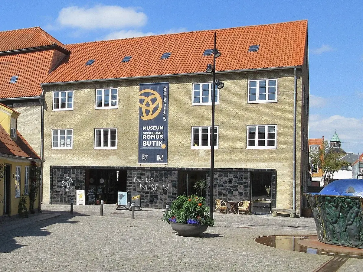 Entrance of Roskilde Museum with signage on a yellow brick building