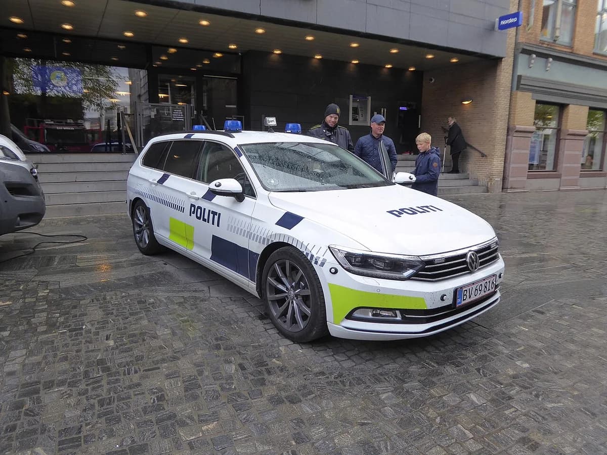 Danish police car parked on street with people nearby