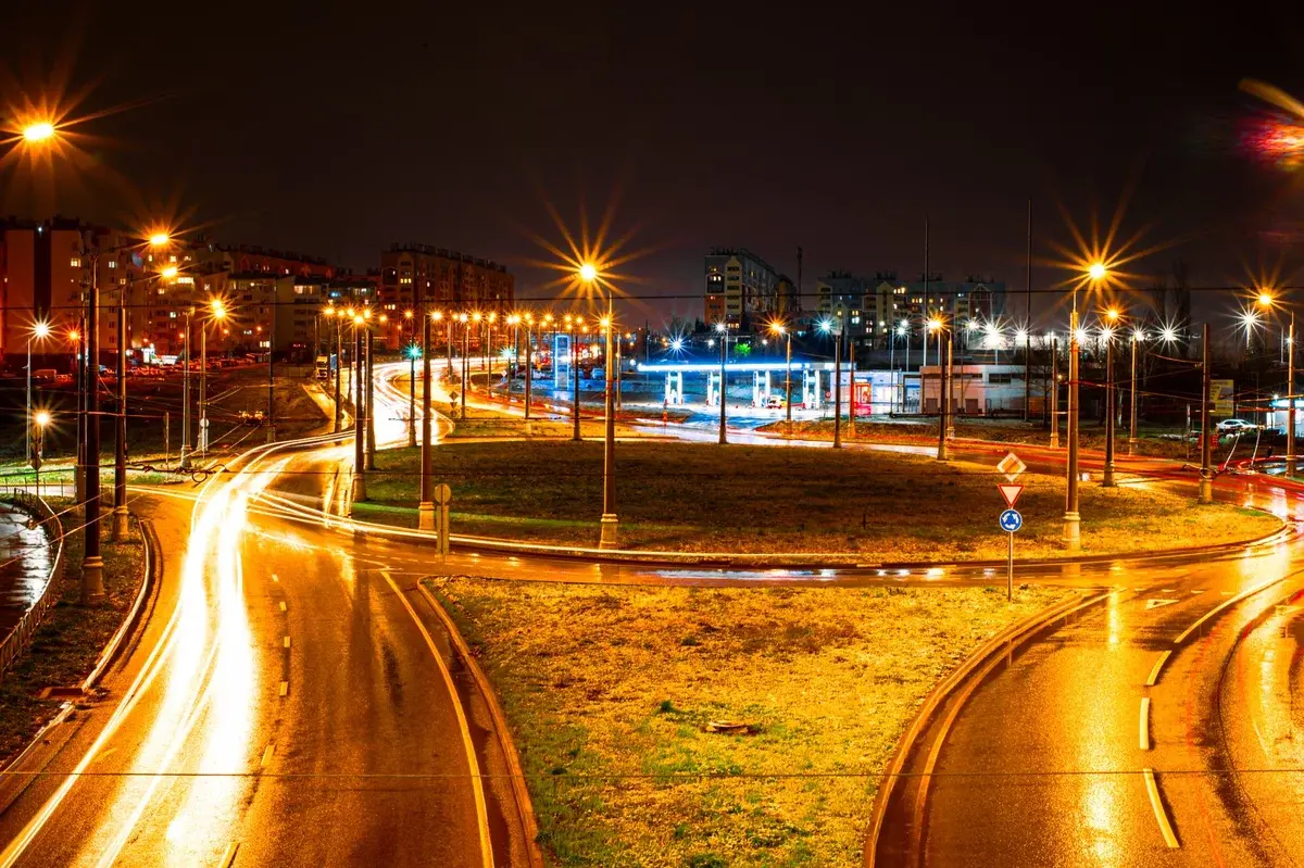 Night long exposure of city roundabout with light trails and streetlights