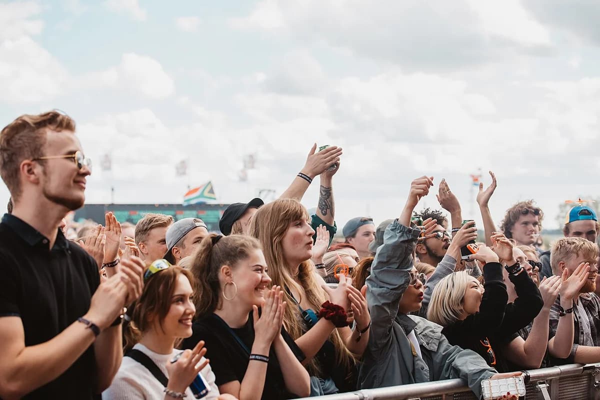 Crowd of people cheering at Roskilde Festival.