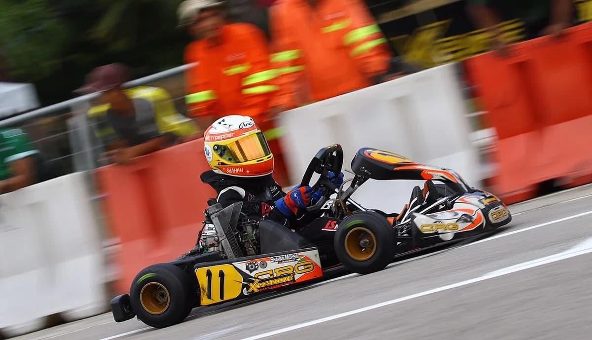 A go-kart racer driving during a race.