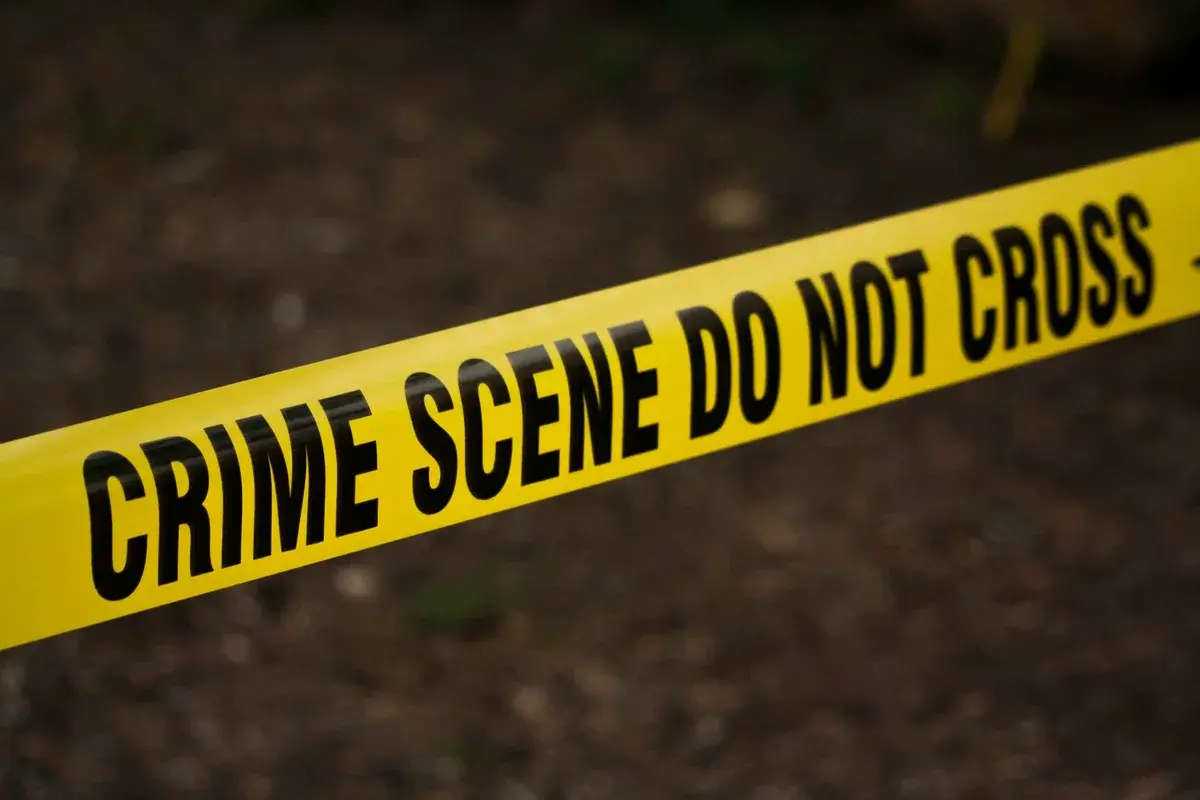 Close-up of yellow crime scene tape with warning text