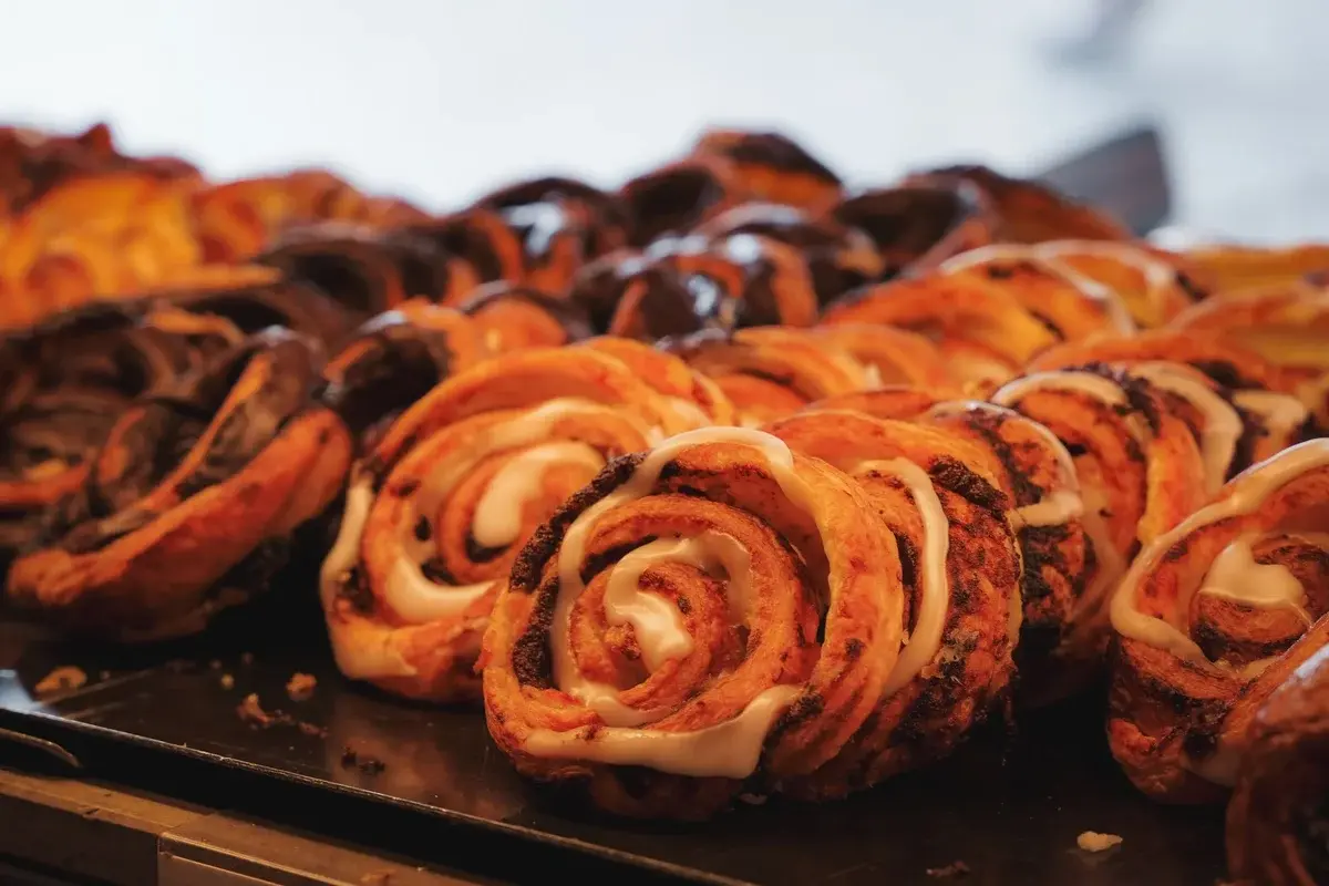 tray of spiral sweet pastries with icing