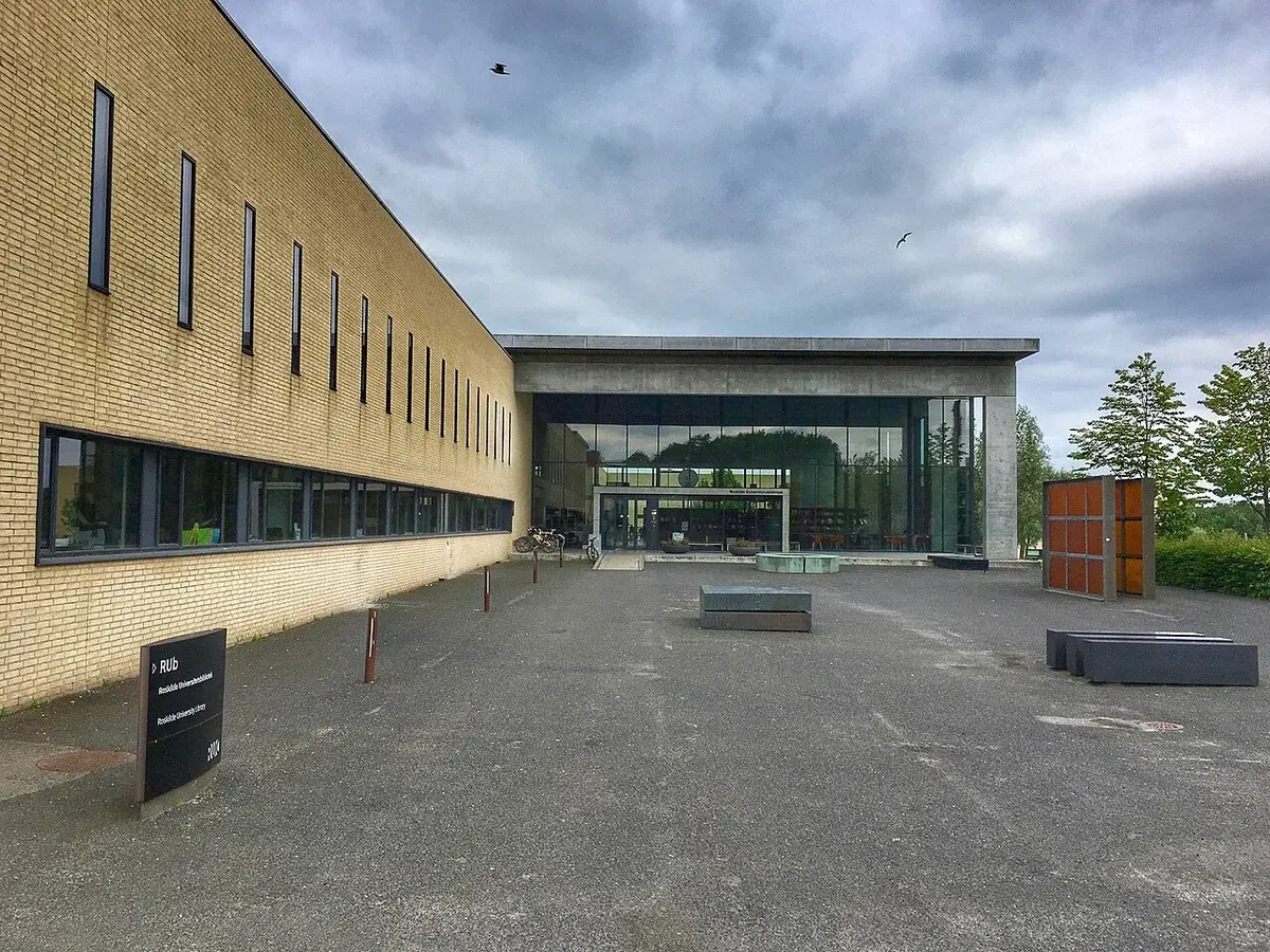 Roskilde University Library entrance with brick and glass facade on a cloudy day