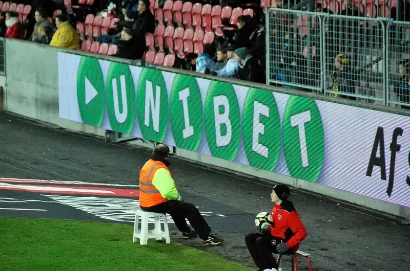 Steward and ball boy at football stadium edge