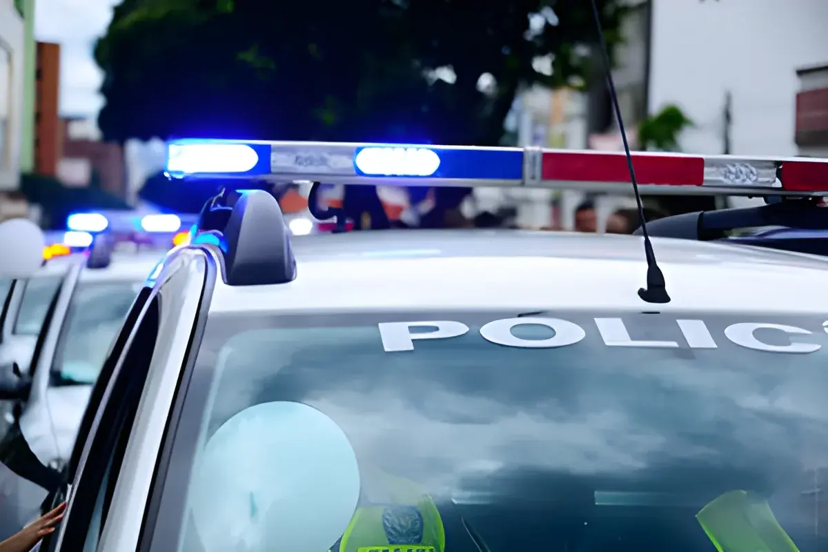 Close-up of white police car with blue sirens blinking