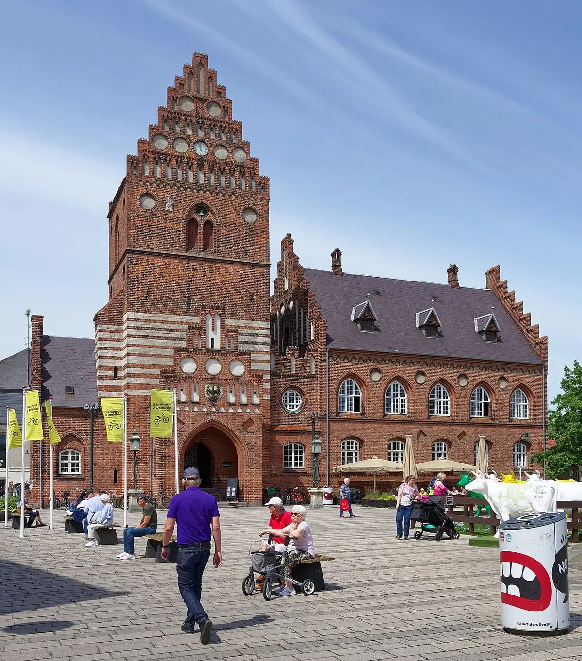 Historic old town hall building in Roskilde, Denmark with people in the square