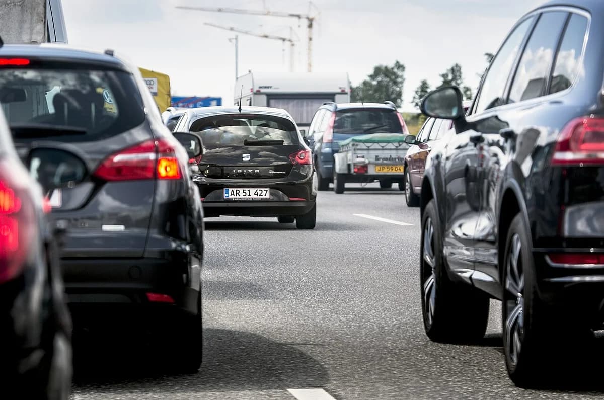 Traffic on a Danish motorway with cars and trucks.