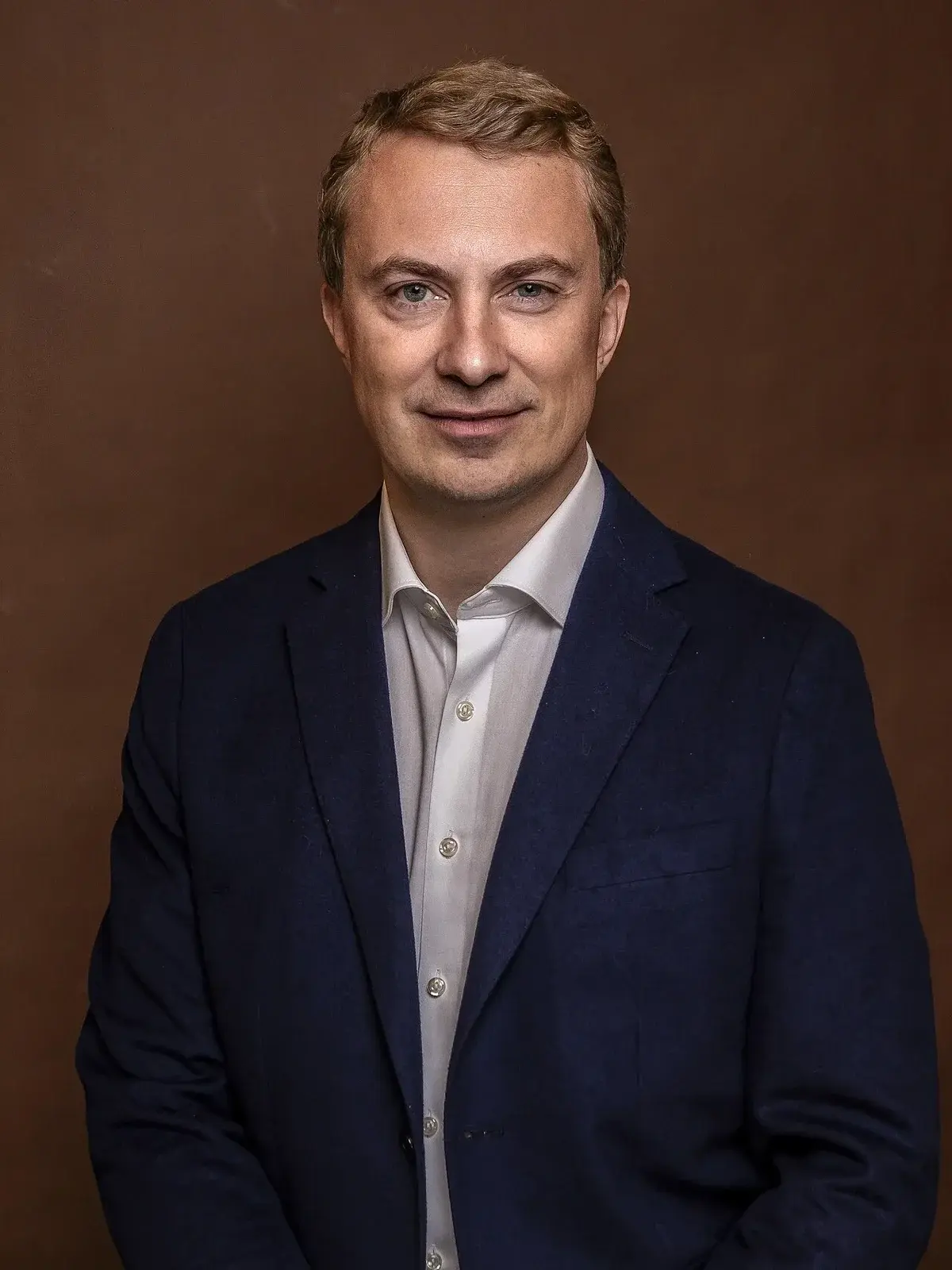 Man in navy blazer and white shirt portrait