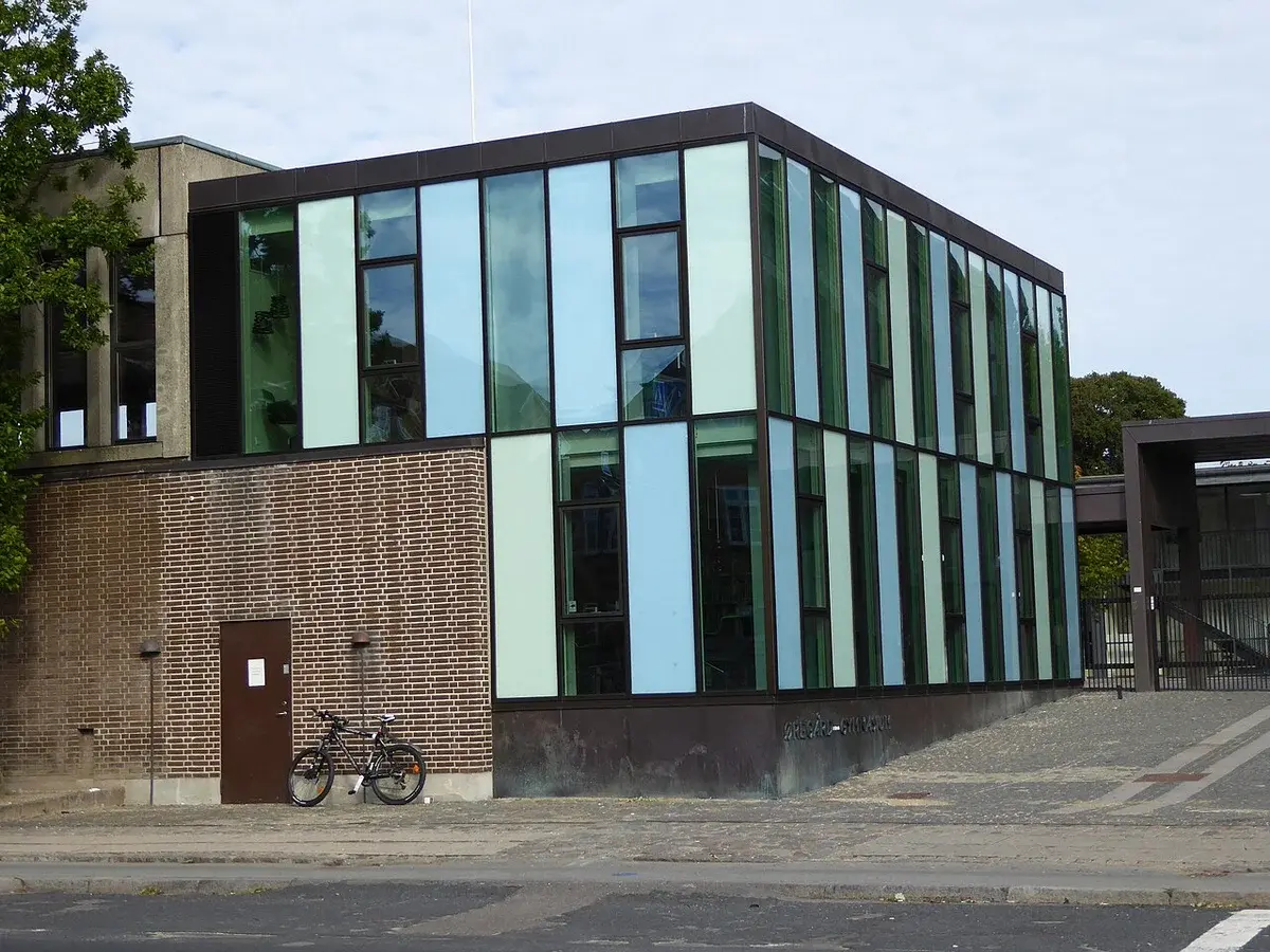 Modern extension of a school building with glass panels and brick walls